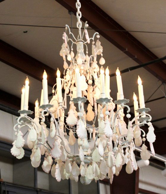 White Chandelier: The chandelier has hanging cut glass pieces across the entire piece and candle stick style lights. The light has two repaired arms and a shabby white painted look. Measures 29" wide and 35" tall witho