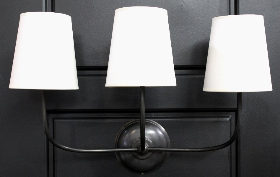 Designer Three Light Wall Fixture: This is a brand new designer light fixture that features a metal frame with three white shades. Measures 14"x21.5"x10"