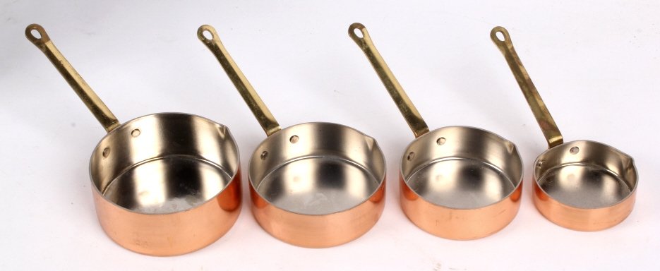 Copper Measuring Cups: The lot features a set of 4 measuring cups made of copper with a brass handle. This includes: 1 cup 3/4 cup, 1/2 cup, and 1/4 cup.