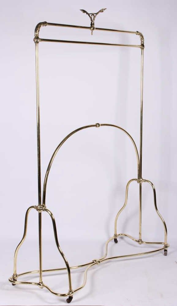 Antique Solid Brass Coat Rack: This is a 19th century solid brass coat rack in great condition with only major dent. The piece has unique and ornate corner and top accents. The piece has wonderful color and casters. This piece has