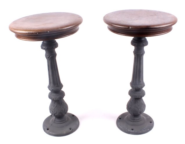 Antique Virginia City Montana Cast Iron Bar Stools: This lot features 2 unique bar stools from Virginia City. They are a matching pair. They are in remarkable condition. The wooden seats have minimal signs of wear and show great patina. Each stool meas