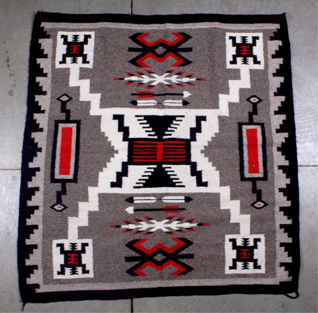 1930's Navajo Rug: This lot features a 1930's Navajo rug. It is 100% wool. This rug has the Storm pattern. It is in very good condition. The rug measures 58" x 61".