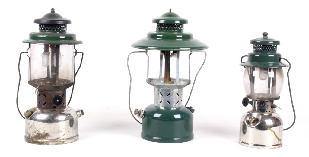 1940-1950's Coleman Lantern Collection: This collection of vintage lanterns includes a model 242B, 220D, and a 228E. Two of the lanterns are coated in a nickel finish, with the third in a classic Coleman color. There is a missing Pyrex cove
