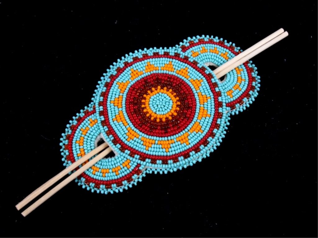 Fort Benton Montana Blackfeet Hair Brooch This is: This is a handmade by the Blackfeet native American in Fort Benton, Montana. This shows a tightly beaded front having a three circle deign using original glass trade beads. All done on Indian tanned l