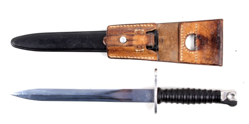 M57 Swiss Wenger Bayonet This is an original 1950': This is an original 1950's Wenger Bayonet with the scabbard and leather frog. The piece is a dress bayonet and is in excellent condition. Measures 14.5" long in the scabbard and 14.25" without.