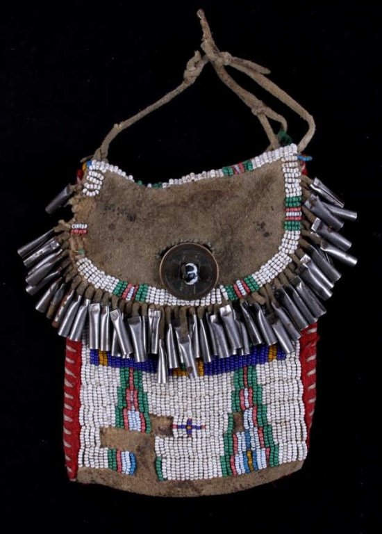 Montana Sioux Strike-A-Lite Bag circa 1870-1890: The bag shows a tightly hand stitched glass trade seed bead design across the front with tin jingle cone fringe and trade clothe. The piece is handmade by a Montana Sioux Native American Indian believ