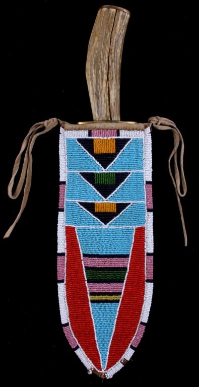 Montana Crow Beaded Scabbard & Dag Knife: The lot shows a beaded knife scabbard from the Montana Crow Native American Indians and a Dag Knife by J.P. Miller. The scabbard shows very tightly beaded top using original 1800's glass trade seed be