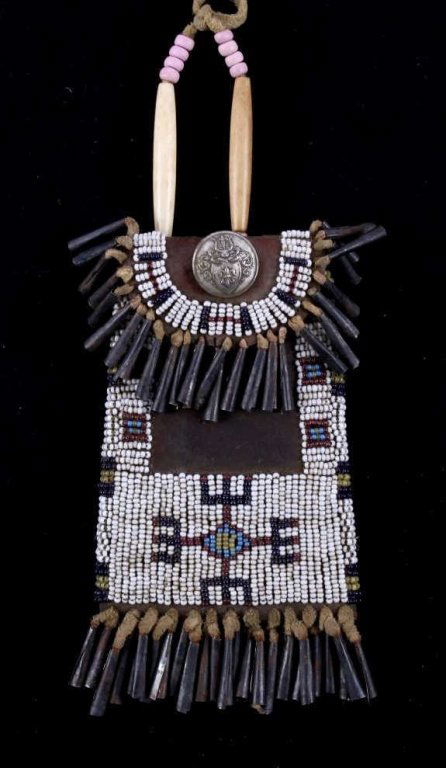Kiowa Strike-A-Lite Bag circa 1880-1890's: The piece features a tightly hand stitched glass trade bead design using 19th century glass trade beads on Indian hide using sinew. The bag is handmade by a Kiowa Native American Indian circa 1880-189