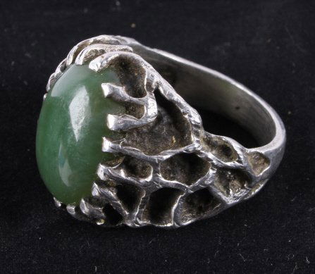 Navajo Silver & Jade Ring Unique Carved Design: The piece is from a Navajo Native American Indian and shows a unique carved Sterling Silver design with a large jade stone. The piece is from the mid 1900's and is a size 10. Measures 7/8"x1"