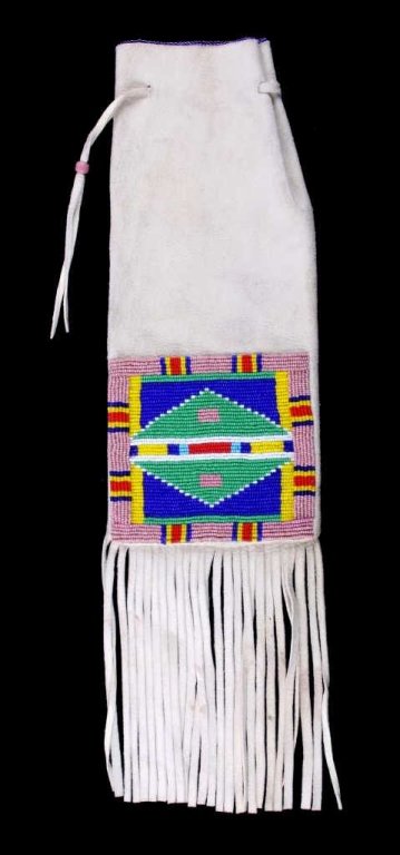 Montana Crow Beaded Pipe Bag This is a Montana Cro: This is a Montana Crow Native American Indian beaded pipe. The bag shows a Indian tanned hide with glass trade bead work across the front and top edge. The piece is in excellent condition and is from