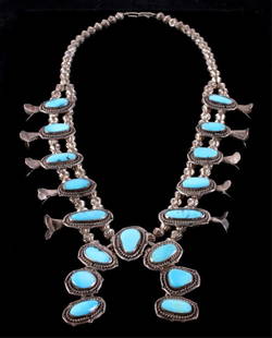 Navajo Sleeping Beauty Turquoise Squash Blossom Th: This piece is hand made by the Navajo Native American Indians and shows hand worked sterling silver with turquoise stones. The necklace shows 17 beautiful bright blue turquoise stones from