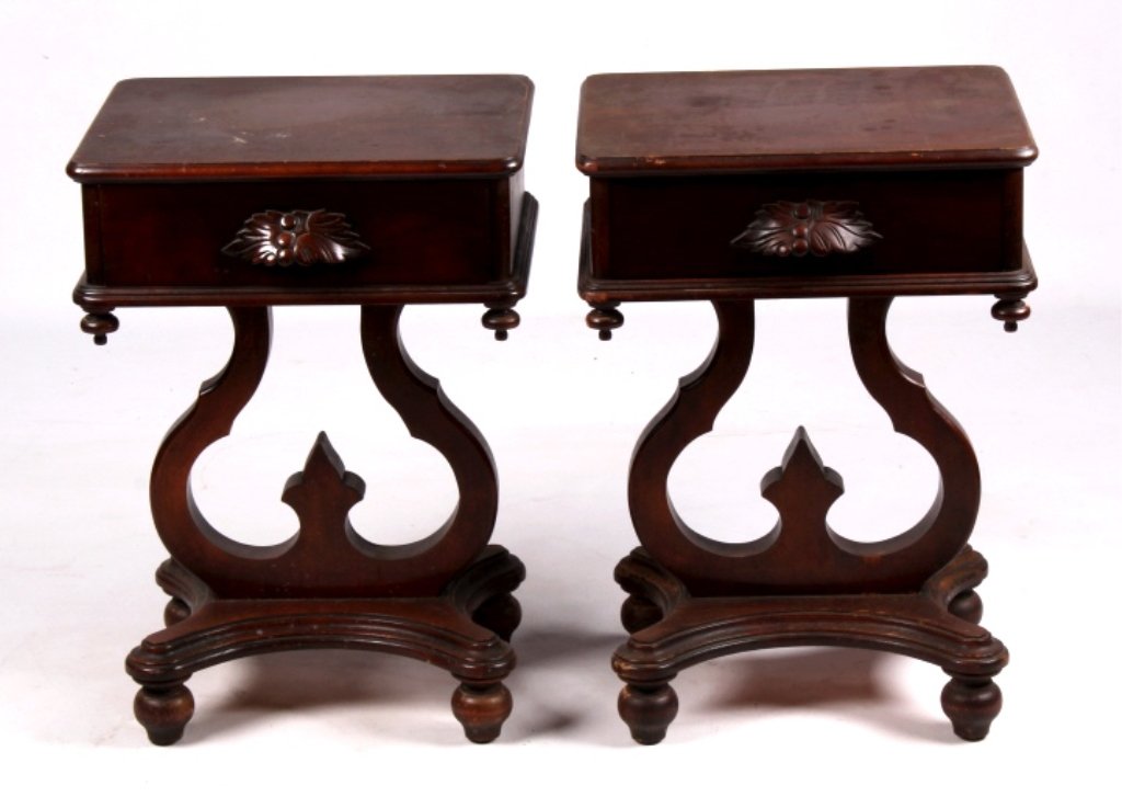 Matching Solid Wood End Tables This lot includes a: This lot includes a pair of solid wood end tables. They have a deep red finish and are in very good condition. They have one drawer with an ornately carved handle. Each end table measures