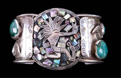Old Pawn Navajo Silver & Chrysocolla Bracelet The: The lot shows a Navajo Native American Indian bracelet. The bracelet has four Chrysocolla set stones. Chrysocolla is the king of carbonate copper gemstones and is one of the strongest colored