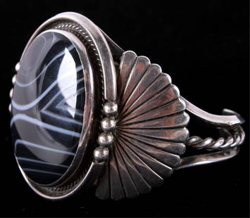 Navajo Spiderweb Obsidian & Silver Bracelet The br: The bracelet shows a large Spiderweb Obsidian stone with wonderful detail and no cracks. The piece is from the Navajo Native American Indians and shows a hand worked silver design. The piece