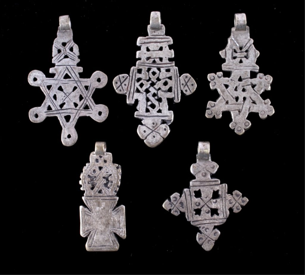 Ethiopian Coptic Silver Crosses The lot shows five: The lot shows five original Ethiopian Coptic Cross pendants. These are all hand made silver pieces showing wonderful designs. The crosses are all unique and have wonderful true antique age. Largest me