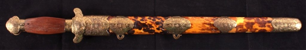 Antique Chinese Dao Double Dagger Sword This lot i: This lot includes an antique Chinese Dao double dagger sword. The scabbard is wrapped with tortoise shell. The daggers and scabbard have fancy engraved brass accents. They are in good condition. The s
