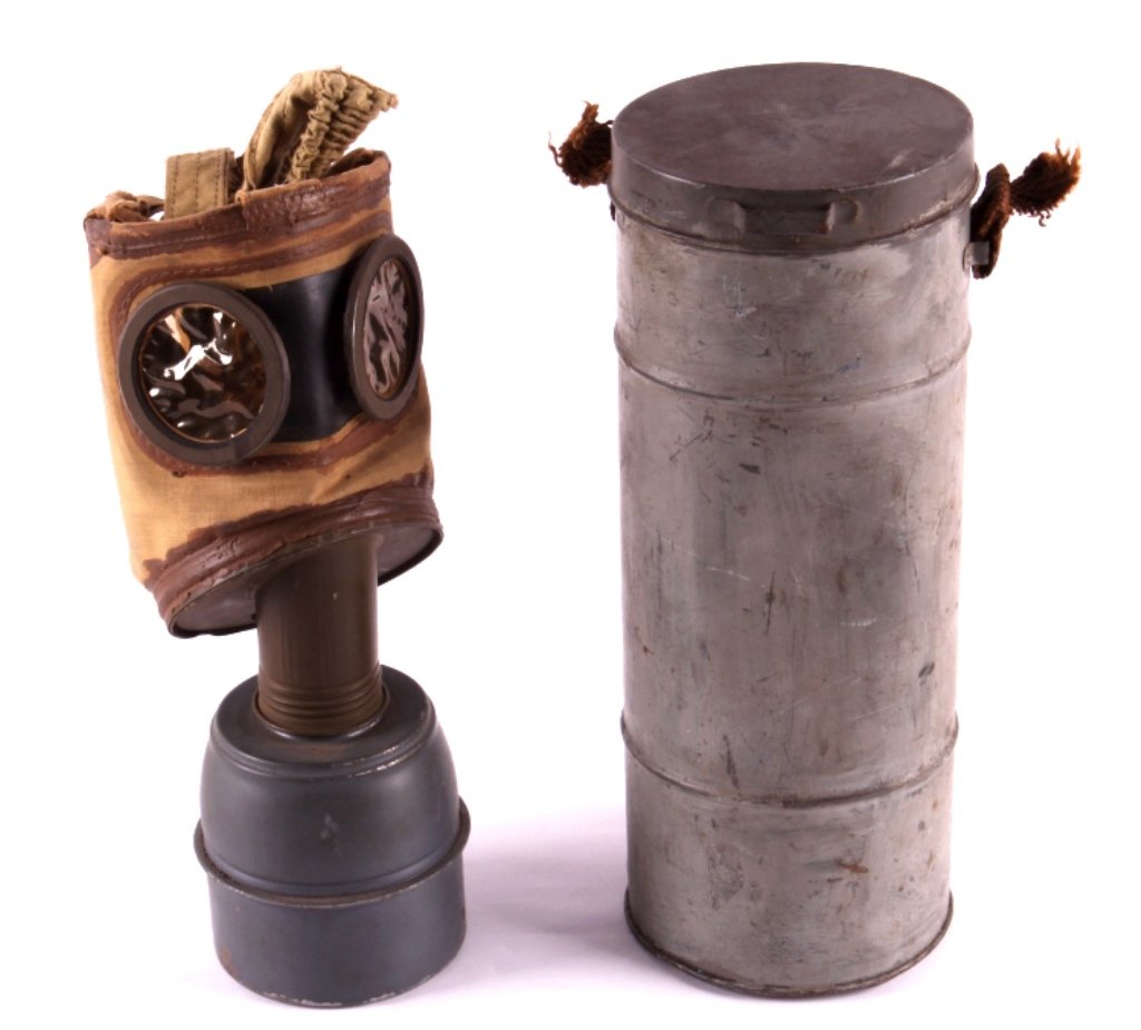 WWII French Gas Mask in Can This lot features a WW: This lot features a WWII gas mask in a can. The gas mask is in original, unused condition. The can is dented in one place. The can measures 4.75" in diameter and is 12".