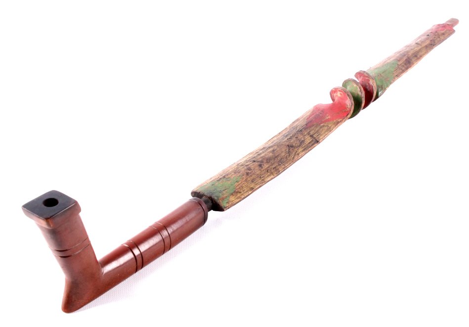 Sioux Twisted Wood & Stone Pipe circa 1890-1900 Th: This is a Sioux Native American Indian pipe stem and bowl. The stem is composed of twisted wood with red and yellow ochre painted designs. The bowl is a carved Pipestone Catlinite piece showing a wond
