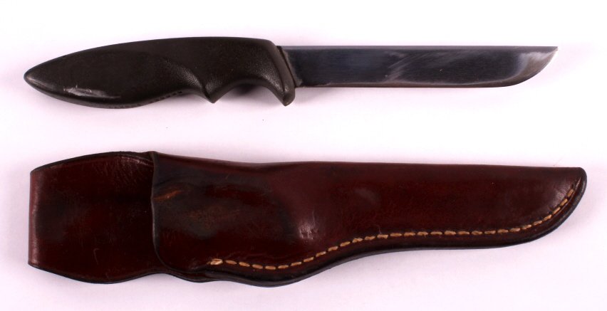 Gerber "Shorty" Knife and Scabbard This lot featur: This lot features a Gerber "Shorty" knife and scabbard. The knife handle is marked "GERBER SHORTY". There is one scuff mark on the handle of the knife. The scabbard is made from leather. It is marked 