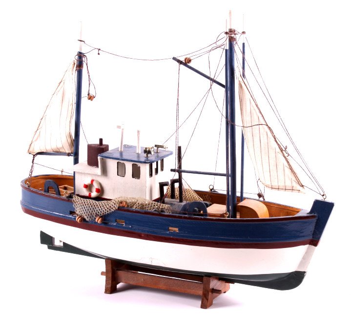 Wooden Fishing Boat Model This lot features a wood: This lot features a wooden fishing boat model. This scale model was made with superior detail. It is complete with the wheelhouse, sails, and fishing net. The wooden fishing boat model is in very good