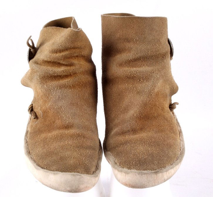 Hopi Indian Moccasins The lot features a set of he: The lot features a set of heavy Indian tanned hide soled Hopi Native American Indian moccasins. These each have a hand tooled silver (believed) concho and heavy leather soles. Mid 1900's. Sole measure