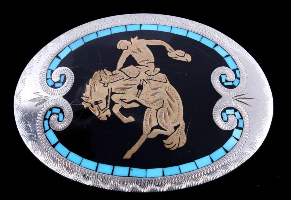 Johnson & Held Bronc Rider Turquoise Buckle The lo: The lot features a "100% Handcrafted Johnson & Held LTD. Dever, Colorado" belt buckle. The piece shows inlaid turquoise stones on a engraved nickel silver frame with a engraved brass bucking bronc rid