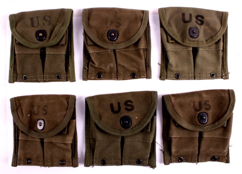 1950's Korea Era M-1 Carbine Magazine Pouches This: This is a collection of 6 1950's Korea era M-1 carbine magazine pouches. Each pouch is dated after 1950. These were worn by infantry soldiers to carry additional magazines for the M-1 carbine which wa