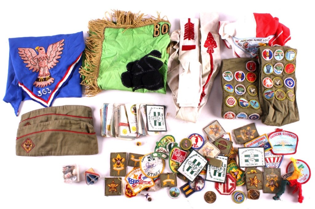 Boy Scout Collection This is a Boy Scout collectio: This is a Boy Scout collection consisting of numerous patches, neckerchiefs, hats, flags, and sashes. Also included are various merit badge awards and a first aid kit. Some of the papers have sustaine