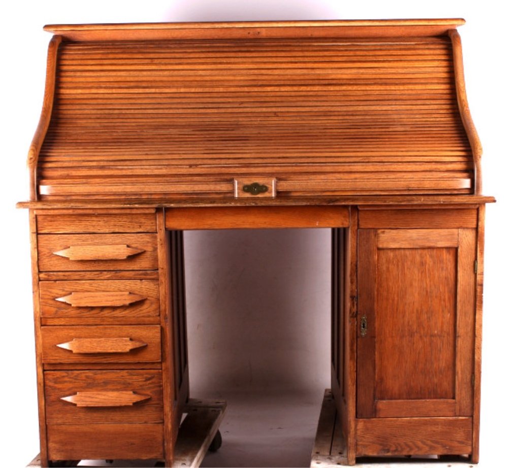 Antique Roll Top Desk This is an antique roll top: This is an antique roll top desk. The desk is made from solid oak. The inside of the desk has a complete set of pigeon holes. The front of the desk has 4 drawers and a cabinet for storage. There is al