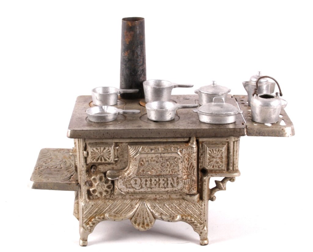 Dent Hardware Cast Iron "Queen" Stove circa 1902 T: This is an original early cast iron nickel finish salesman sample stove manufactured by Dent Hardware circa 1902. The stove is the "Queen" Model and shows an embossed and inset scroll design and appea