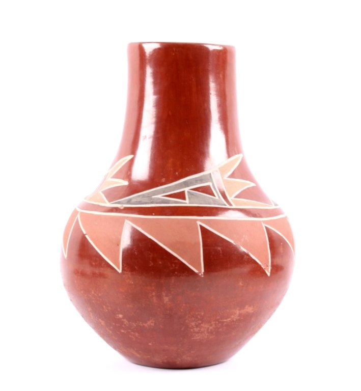 Santa Clara Indian Pottery This is a hand formed p: This is a hand formed pottery vessel from the Santa Clara Pueblo Native American Indians. The piece is bear claw red with a wonderful polychrome painted geometric design. This is a mid century piece s