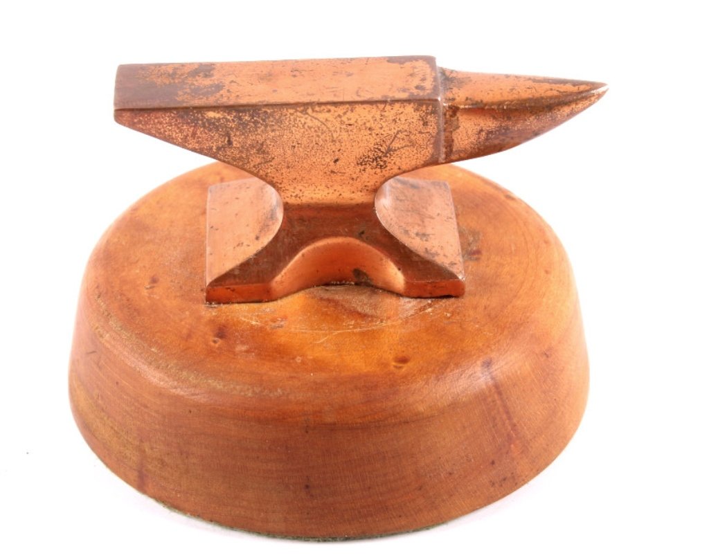 Butte Montana Copper Jewelers Anvil This is a smal: This is a small Jewelers anvil that appears to be made of solid copper and is from Butte, Montana. The piece could be used as a jewelers anvil, toy, or salesman sample. On wood plaque. Measures 2.5"t 