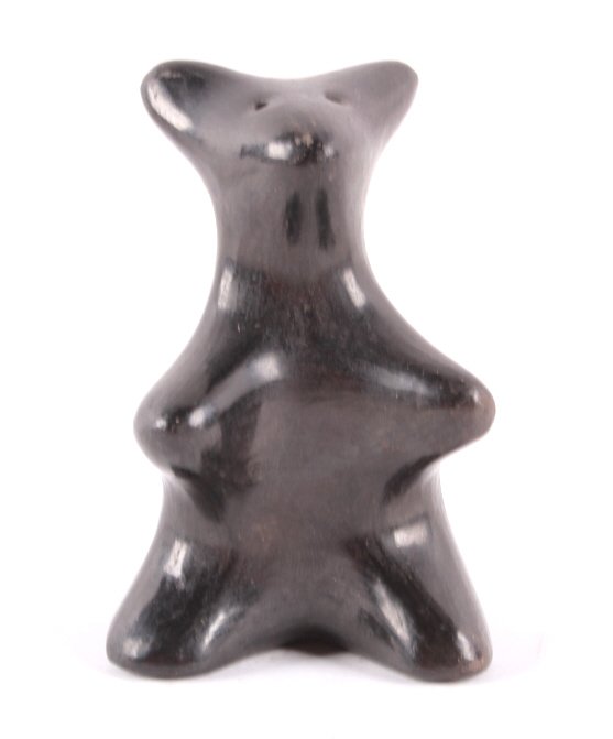 San Ildefonso Black on Black Bear by Delores This: This is a San Ildefonso Native American Indian black on black pottery bear figure. The bear effigy is signed by Delores and shows good condition. Rare piece. Mid Century. Measures 2.75" tall.