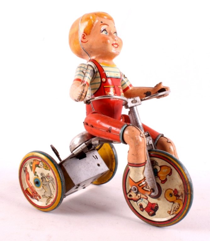 Kiddy Cyclist Tin Lithograph Wind Up Toy This is a: This is a Kiddy Cyclist tin lithograph wind up toy. It was made by "Unique Art Mfg. Co., Inc.". This unique toy features a jointed child figire riding a tricycle. It has a wind up mechanism with a "St