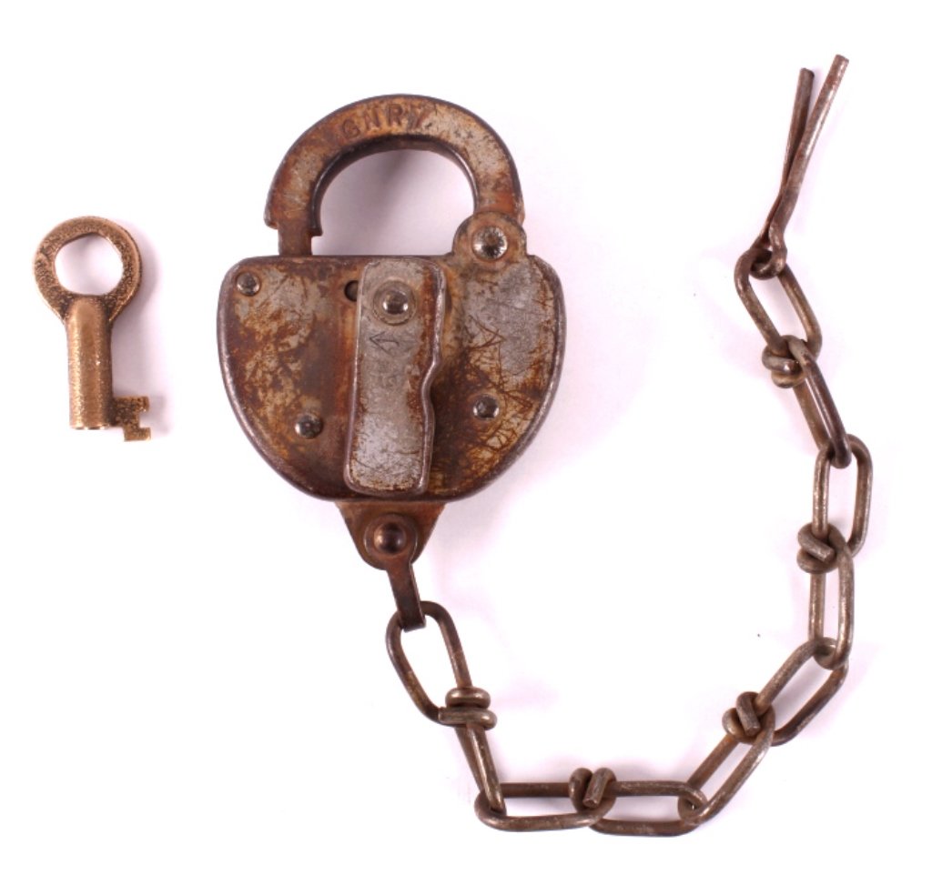 Great Northern Railway Switch Lock with Key: This is a Great Northern Railway switch lock with key. The lock is marked "GNRY". It comes with the original brass key and is in good condition. It measures 3" x 4" and the chain is 9.5".