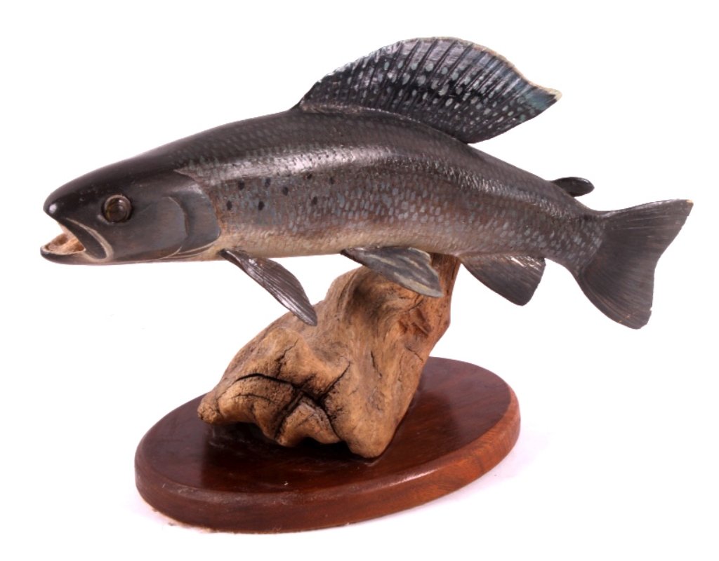 Ed Totten Carved Wooden Arctic Greyling: This is a carved wooden Arctic Greyling. The greyling was hand carved and painted by Montana artist Ed Totten. It shows great detail and bright, vivid colors. The piece has been signed by the artist.