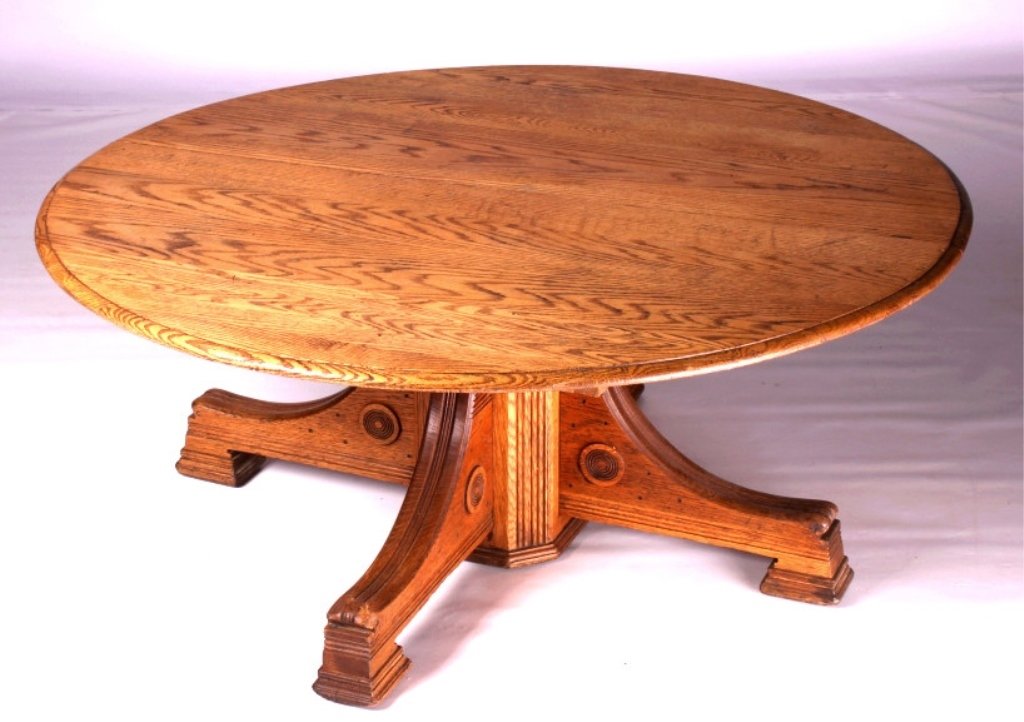 Antique Round Oak Coffee Table: This is an antique round oak coffee table. This table was originally a dining room table. It is made from solid oak and features a beautifully carved pedestal. The coffee table is in good condition. T