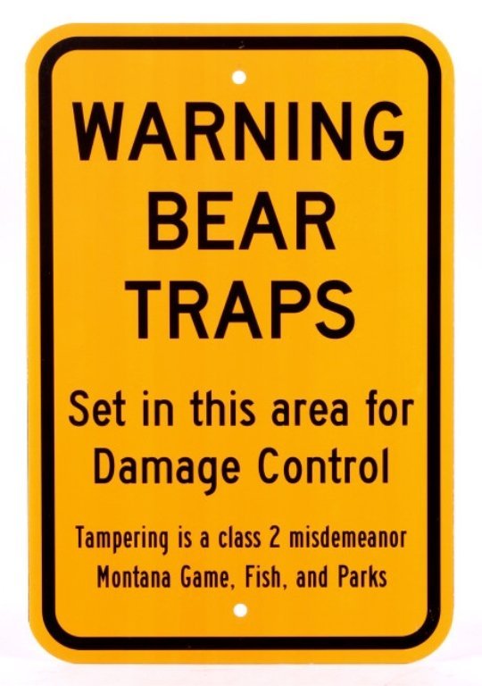 Montana Game Fish, & Parks Bear Trap Sign: This lot features a bear trap sign. This sign was used to designate an area that had bear traps set. The sign was utilized by the Montana Game, Fish, and Parks to warn people that traps were set in th