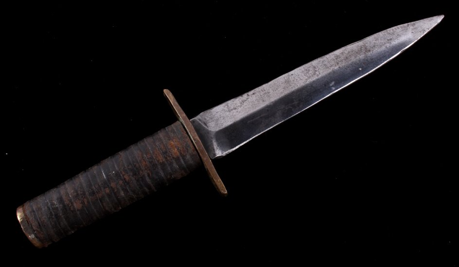 WWII Nazi Boot Fighting Knife: This is a World War II Nazi Germany fighting boot knife. The knife shows a leather wrapped handle with double edged blade and brass hilt. This is most likely manufactured by Puma or Tiger in Solingen,
