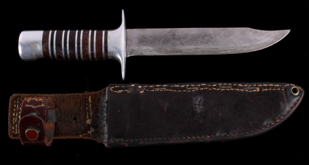 WWII Theater Made Trench Art Fighting Boot Knife: This is a hand made trench art theater made World War II knife with leather scabbard. The piece would have been used as a fighting boot knife. This shows an impressive leather and metal handle in good