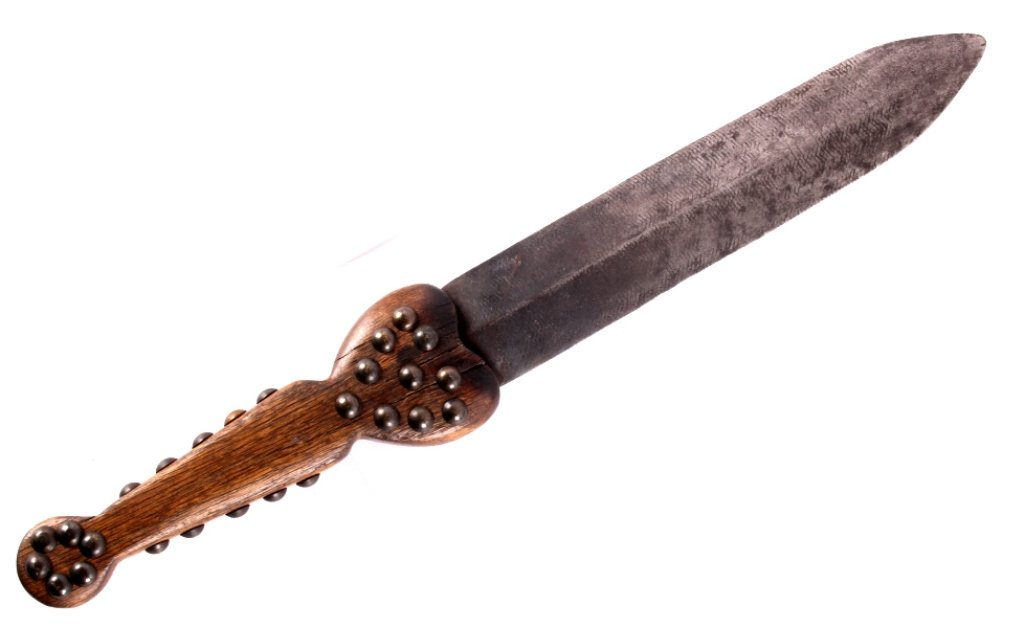 Blackfoot Beaver Back Dag circa 1850: The piece is a very fine and important rare Blackfoot Native American Indian Beaver Back Dag. The piece is made from a blacksmiths large rasp file showing a craved maple handle with various brass cove