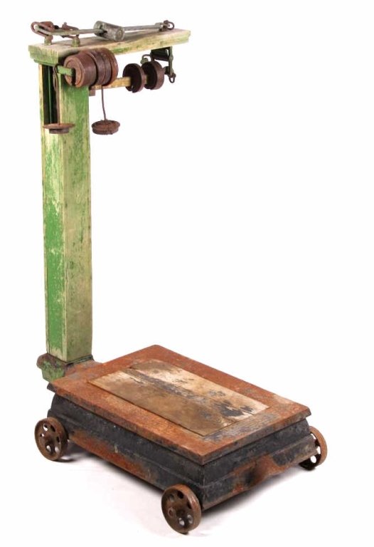 Antique Platform Scale with Weights: This is an original cast iron and wood early antique platform scale. The scale comes with two brass or copper balance beams and a collection of early scale weights. The piece has a wonderful decor loo