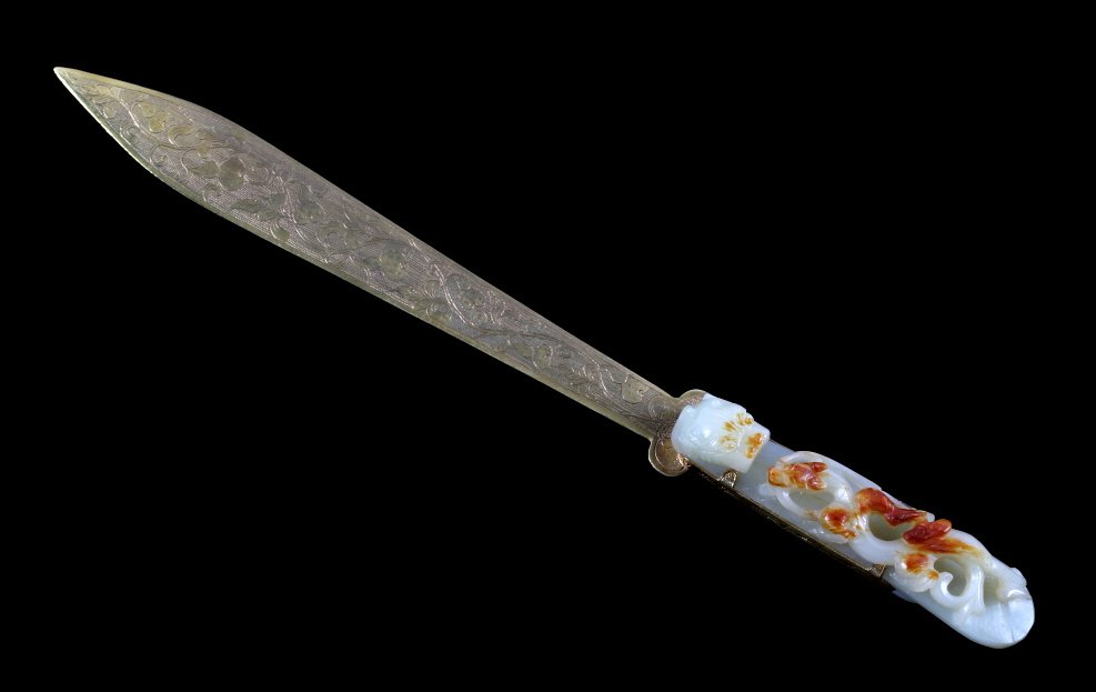 Chinese Jade Belt Hook Letter Opener 17th-18th c.: The piece features a wonderfully carved white and red jade belt hook on a finely crafted brass letter opener. The belt hook is very finely carved showing a rare Imperial mythological scene with a mean
