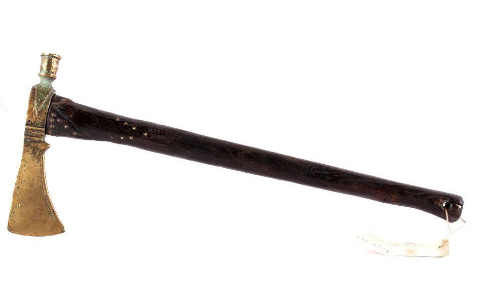 Shawnee Brass Hammer Poll Tomahawk 1800-1850: The piece is a Shawnee Native American Indian tribe Hammer Poll Tomahawk with wood handle and brass tomahawk head. The weapon shows a carved wood handle with brass tacks decorating the upper carved ar