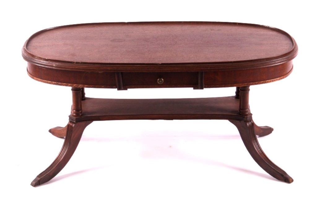 Antique Duncan Phyfe Coffee Table: This is a Duncan Phyfe coffee table. The coffee table features the iconic sweeping curved legs. The raised edge on the top indicates the table had a glass top at one time. The table has one drawer tha