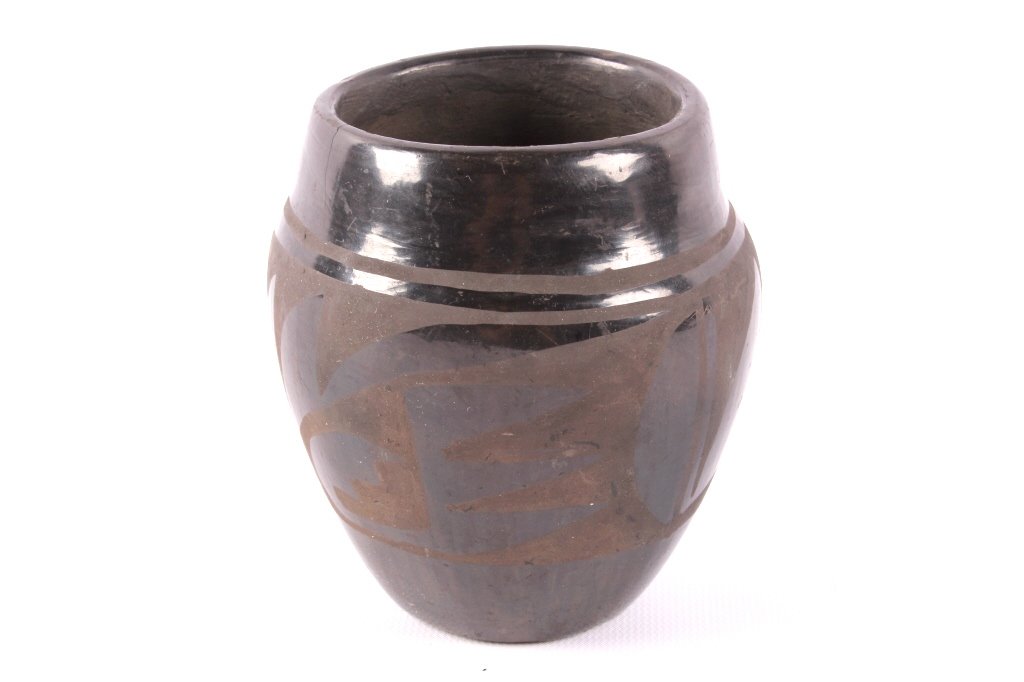 San Ildefonso Black on Black Pottery Bowl: The piece is from the San Ildefonso Pueblo Native American Indians and shows a wonderful piece of black on black pottery. The bowl has a wonderful geometric design and shows good condition with no chi