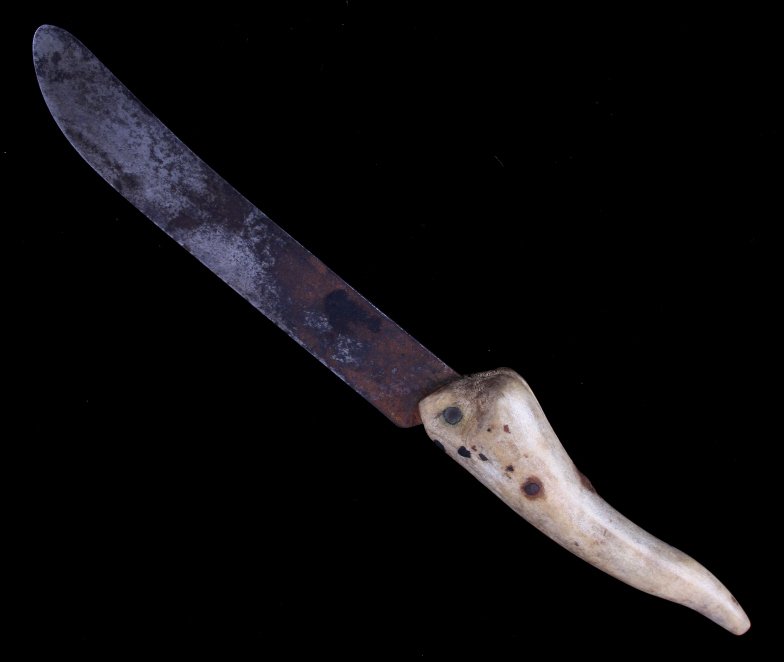 Crow Indian Antler Handle Trade Knife: This is a hand crafted trade knife from the Crow Native American Indians. The piece shows a metal blade with Elk antler tip handle being held together with a copper rivet. The piece is from the 19th c