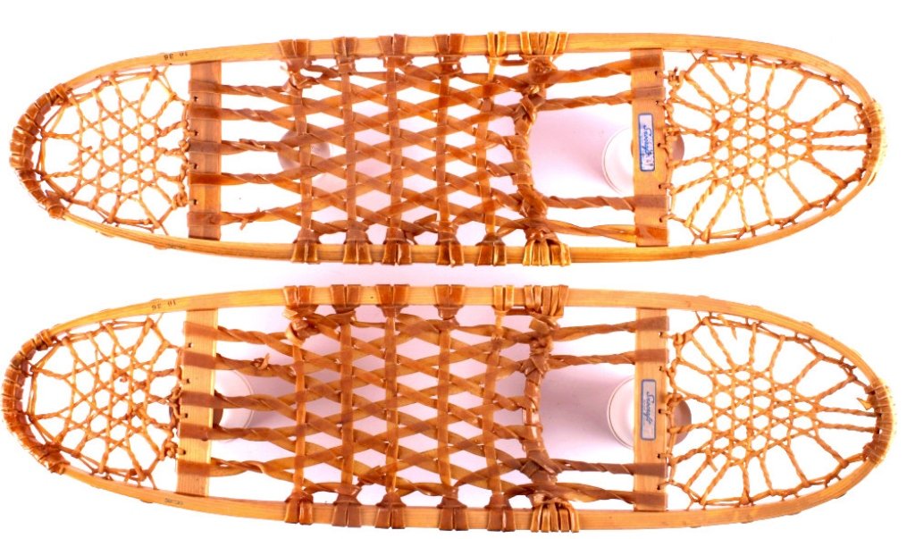 Bear Paw Rawhide Laced Snowshoes: This is a pair of Bear Paw rawhide laced snowshoes. The snowshoes were made by Snocraft. The snowshoes show good condition. They measure 9.5" x 35.75".