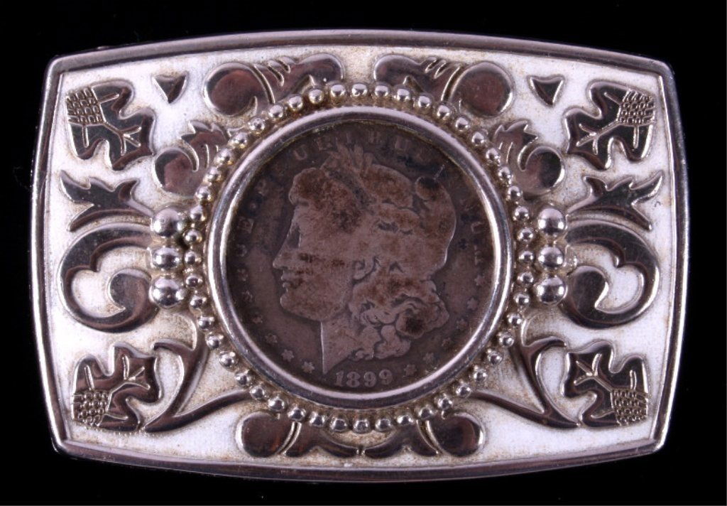 Morgan Silver Dollar 1899 Gamblers Belt Buckle: This is an 1899 Morgan Silver Dollar set in an antique gamblers Western cowboy belt buckle. The buckle shows a well circulated Morgan silver dollar from 1899. The silver dollar is held by a fancy beze
