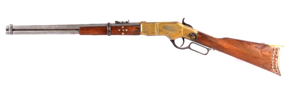 Winchester 1866 Lever Movie Prop Rifle 1940's: This is a 1940's movie prop lever action rifle. The rifle is a replica of the 1866 Henry Winchester lever action saddle ring carbine. The gun features a non-firing working action. It has a brass gold 